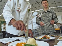 Chef Christopher Rolack, Culinary Arts Fair judge, tastes a rice dish prepared by one of the teams visiting Baumholder during the second annual Culinary Arts Fair Feb. 13.