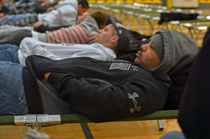 “Evacuees” rest while awaiting transportation.