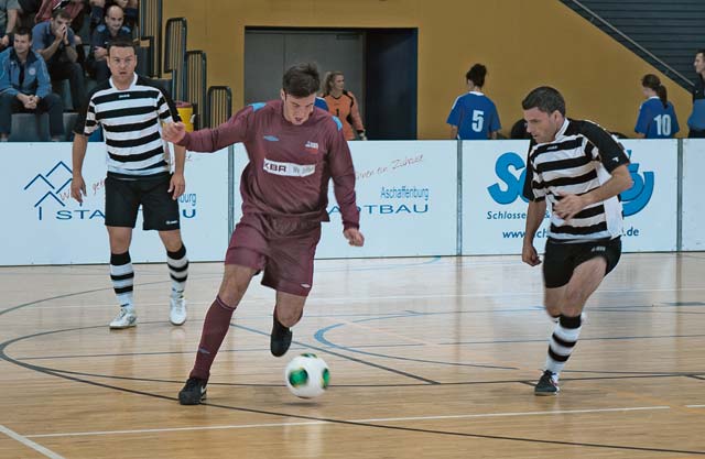 A member of the British Royal Air Force dribbles a ball past a Belgian air force player during the football championship game.