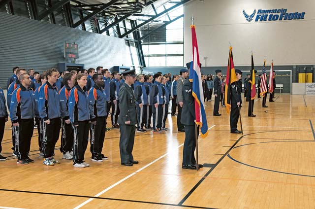 U.S. Air Forces in Europe and Air Forces Africa, Royal Netherlands air force, German air force, Belgian air force, Polish air force and British Royal Air Force football teams stand at  attention during the closing ceremony of the Headquarters Allied Air Command Indoor Football Championship games Sept. 25 on Ramstein. The Polish air force’s men’s team and the German air force’s women’s team were the overall winners of the 2013 championship.