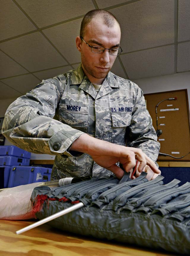 Senior Airman Gabriel Morey, 86th Operations Support Squadron aircrew flight equipment technician, pulls parachute lines through the shoot to ensure they properly deploy.