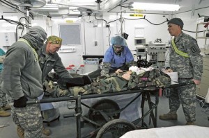 Members of the 212th Combat Support Hospital prepare a simulated casualty for surgery in the operating room during a field training exercise March 15 in Miesau. The OR is one of two in the 64-bed field hospital that is constructed of dozens of tents and specially designed metal containers.