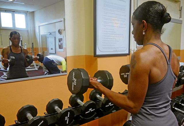 Avril Marlow Featherstone focuses on form during a bicep curl.