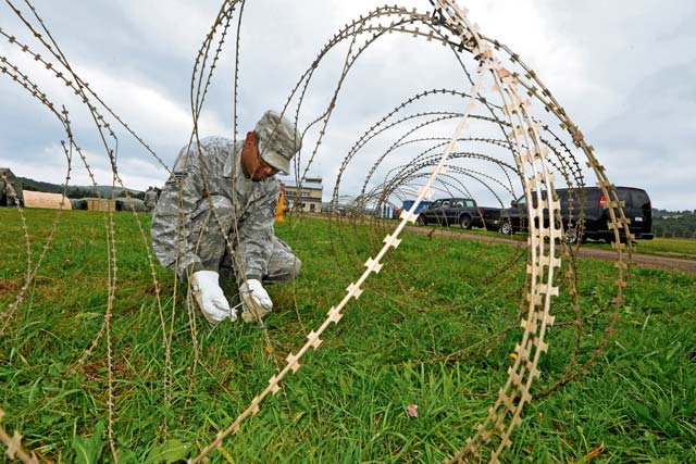 Staff Sgt. Kenneth Hawkins, 1st Air and Space Communications Squadron client system technician, secures the area around a communication control point  during Exercise Market Orchard.