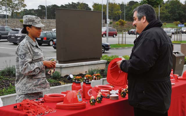 Felipe Vazquez, 86th Civil Engineer Squadron Fire Department assistant chief for fire prevention, talks to a member of Team Ramstein about the importance of checking smoke detectors. The theme for this year’s Fire Prevention Week was testing smoke detectors twice a year.
