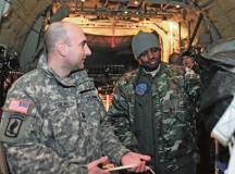 Capt. Thomas F. Torchia (left),  Central Accord 14 Phase I OIC assigned to the 173rd Airborne Brigade Combat Team, explains how a bundle is dropped from a C-130 aircraft during an airborne operation to Nigerian Lt. Col. Seun A. Kuponiyi during Central Accord 14 Phase I Feb. 5 on Ramstein.