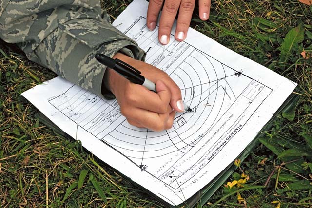 An Airman goes over a field range card.