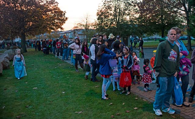 Trick-or-treaters wait in line to receive candy during Trunk-or-Treat.