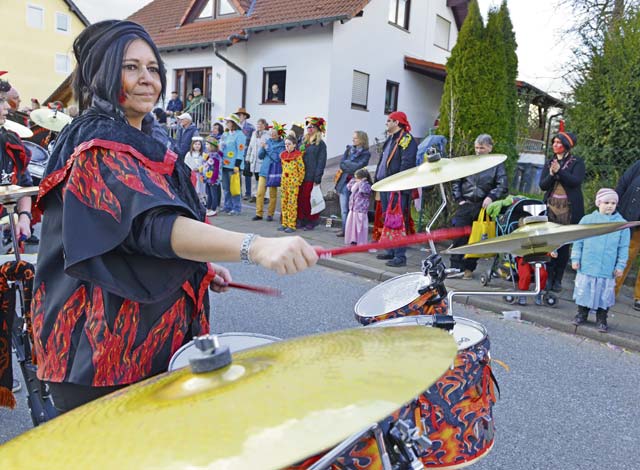 Photo by Airman Dymekre AllenA women plays the drums during the Fasching parade.