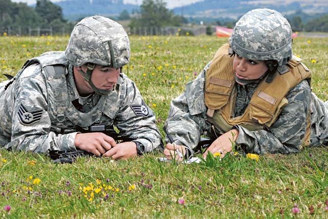 Staff Sgt. John Smith, 435th Security Force Squadron fire team leader, trains Senior Airman  Ashley Fagan, 435th Air Mobility Squadron knowledge operations management, on field range cards.
