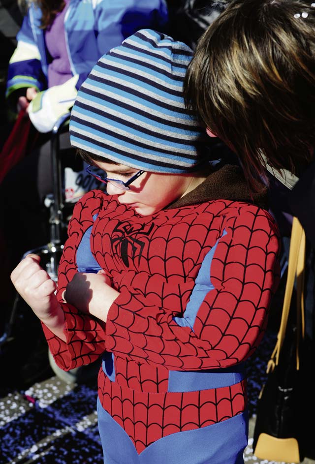 Photo by Senior Airman Hailey HauxSpiderman flexes his muscles for his mom during the Fasching parade March 4. 