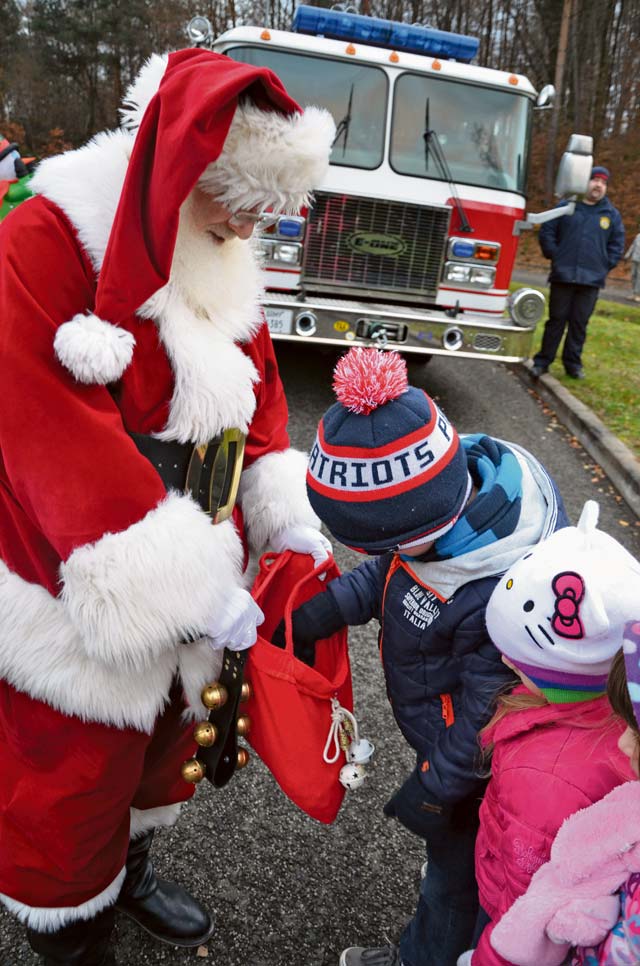 Photo by Elizabeth BehringSaint Nick passes out goodies to children on Pulaski Barracks Dec. 5 during a tree lighting event.