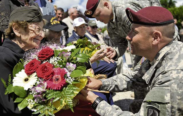 Photo by Staff Sgt. Sara KellerEllan Levitsky-Orkin, a Delaware native who served as a U.S. Army nurse in Normandy during World War II, speaks with a U.S. Army paratrooper during a ceremony to honor their service June 4 in Bolleville, France. The event was one of several commemorations for the 70th anniversary of D-Day operations conducted by Allied forces during World War II June 5 and 6, 1944. More than 650 U.S. military personnel have joined troops from several NATO nations to participate in ceremonies to honor the events at the invitation of the French government.