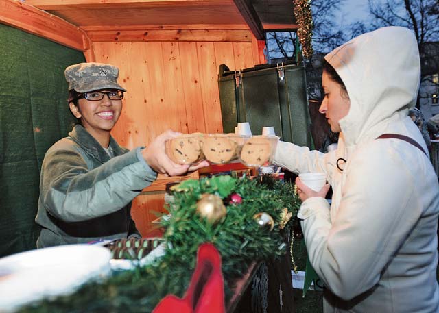 Photo by Spc. Iesha HowardPvt. Katherine Moore, a material manager with the 21st Theater Sustainment Command, offers refreshments to Soldiers and family members.