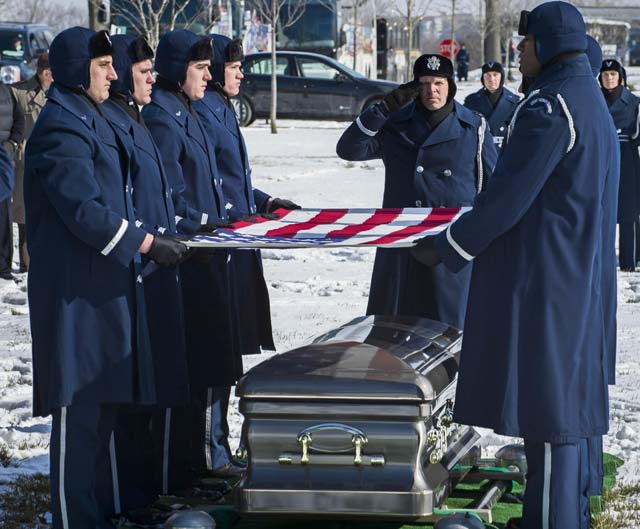 Photo by Jim VarhegyiPal bearers from the U.S. Air Force Honor Guard fold the flag draped over the the casket of Brig. Gen. Robinson "Robbie" Risner during his internment ceremony Jan. 23 at Arlington National Cemetery in Arlington, Va. Risner was the Air Force's 20th ace, and he survived seven and a half years of captivity as a prisoner of war in Hoa Lo Prison during the Vietnam War. 