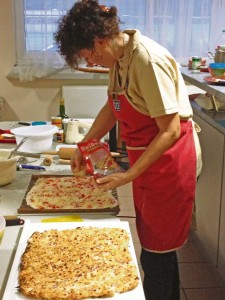 Photo by Cori Bolger ShirkKarin Ullrich, a German cooking instructor for the Kaiserslautern USO, puts the final touches on a flammkuchen dish during a recent class held at Kapaun. Using locally purchased ingredients, Ullrich taught the class how to make several varieties of the traditional dish, which originated in France and is now popular in this region of Germany. 