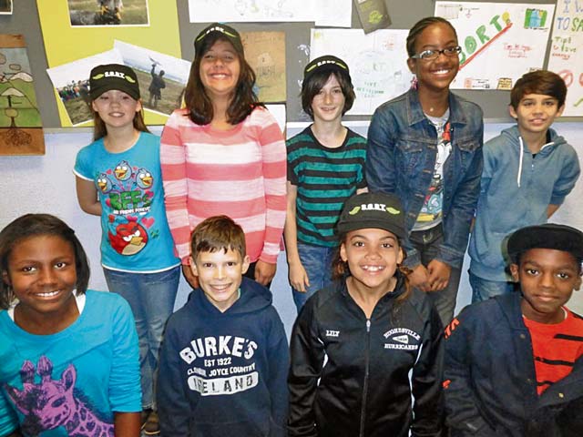 Courtesy photoS.O.R.T. talks energy conservation(Back row, left to right) Ashton Bailey, Jocelyn Fajardo, Justin Doyle, Maya Parker, Gabriel Azua, (Front row, left to right) Cheyenne Neurell, Colton Burke, Lily Butler and Jared Orney, sixth-graders at Ramstein Middle School, are visited by members of Ramstein's Save Our Resources Team to talk about energy conservation during Energy Action Month. Students competed in a poster contest for energy awareness. The posters were displayed at the school and the top performers were awarded S.O.R.T. caps, marking them as true energy savers!  