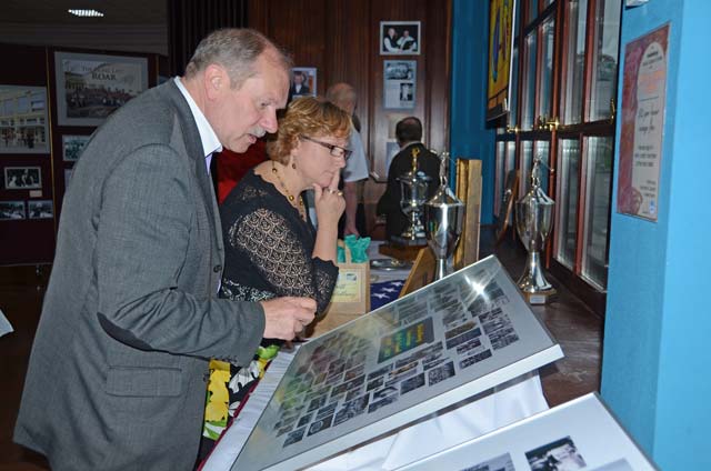 Heidelberg residents Suzann Mayfield and Norbert Hooks look at a collection of class photos from Heidelberg High School during the opening of the Farewell Heidelberg multimedia exhibit June 1 at the Village Pavilion Community Center on Patrick Henry Village in Heidelberg. 