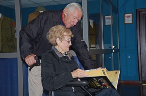 Dr. and Mrs. David Aronson sneak a peek inside of the Farewell Heidelberg commemorative book during their visit.