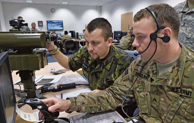 From left to right, Czech Republic armed forces Staff Sgt. Petra Manhart, 13th Artillery Brigade artillery reconnaissance platoon gun commander, works with U.S. Army Sgt. Matthew England, 2nd Calvary Regiment infantryman, in the first ever multinational Joint Fire Observer course taught July 25 on Einsiedlerhof Air Station.