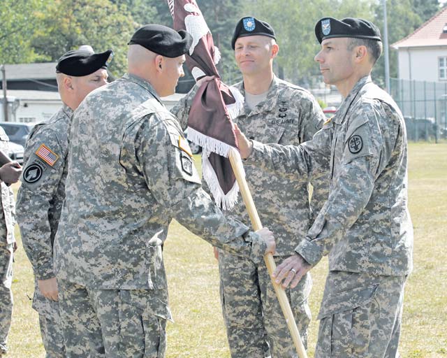 Photo by Linda SteilLt. Col. Lawrence Burns accepts the colors of the Warrior Transition Battalion-Europe from Col. Scott Ehnes, Europe Regional Medical Command chief of staff, during a change of command ceremony June 18 on Daenner Kaserne in Kaiserslautern. The WTB-E provides critical support for wounded, ill and injured Soldiers who are expected to require six months or more of rehabilitative care and complex medical management and to ensure both the Soldiers and their families are cared for. The battalion has units at 14 different locations in Belgium, Germany and Italy.