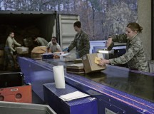 Members of the 86th Communications Squadron post office unload and scan incoming mail Dec. 4 on Ramstein. The post office on Ramstein supports approximately 57,000 KMC members.