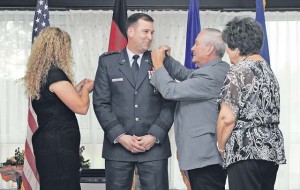  Maj. Gen. Christopher Bence, 3rd Air Force vice commander, has his family pin on his new rank during a promotion ceremony July 29 on Ramstein. Bence was recently selected as the vice commander by Gen. Frank Gorenc, U.S. Air Forces in Europe and Air Forces Africa commander. He is coming from his position as the USAFE-United Kingdom commander. 