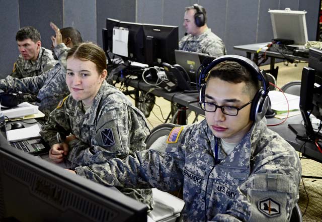 Pfc. Andrew Hernandez (right), intelligence analyst with B Co., 24th Military Intelligence Battalion, 66th Military Intelligence Brigade, and Spc. Andrea Willette (left), intelligence analyst with Headquarters and Headquarters Battery, 10th Army Air and Missile Defense Command, chart  missile  launches during a simulated missile volley. The Soldiers are training with others from across U.S. Army Europe in a 10th AAMDC missile defense  exercise.