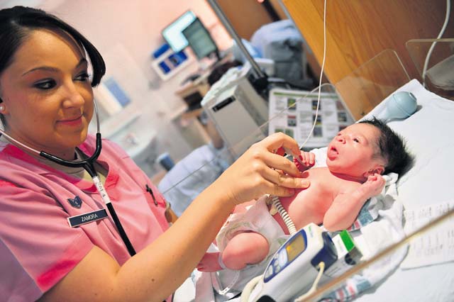 Photo by Tech. Sgt. Daylena RicksStaff Sgt. Tara Zamora, 86th Medical Squadron medical technician, checks an infant’s temperature at Landstuhl Regional Medical Center. LRMC is the largest American hospital outside of the U.S.