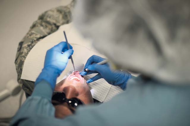 Photo by Airman 1st Class Michael StuartAirman 1st Class ChellAnn Reale, 86th Dental Squadron dental technician, cleans a patient’s teeth. The 86th DS provides many services, including oral health assessments, cleanings, retainers, bridges, dentures, crowns, implants and fittings for mouth gear.