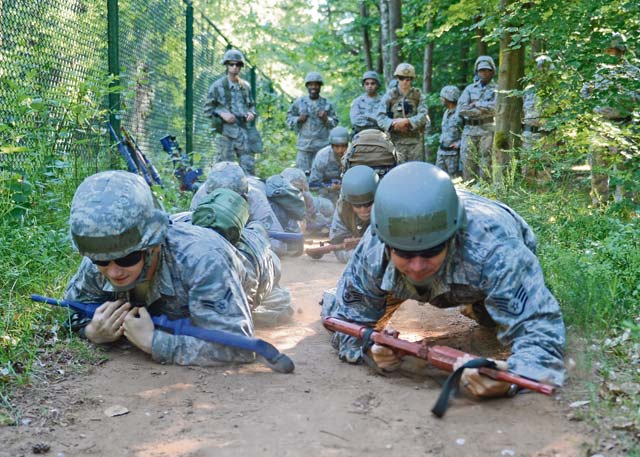 Photo by Airman 1st Class Michael StuartAirmen high-crawl through the woods during Prime BEEF (Base Engineer Emergency Forces) Day June 13, 2014, on Ramstein. From Self-Aid and Buddy Care to weapons handling, the 86th Civil Engineer Squadron conducts Prime BEEF training to sharpen their contingency skills.