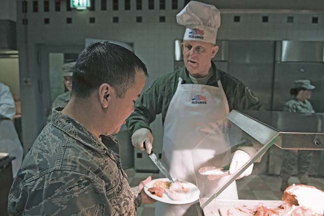 Gen. Frank Gorenc, U.S. Air Forces in Europe and Air Forces Africa commander, serves turkey to a guest on Thanksgiving.