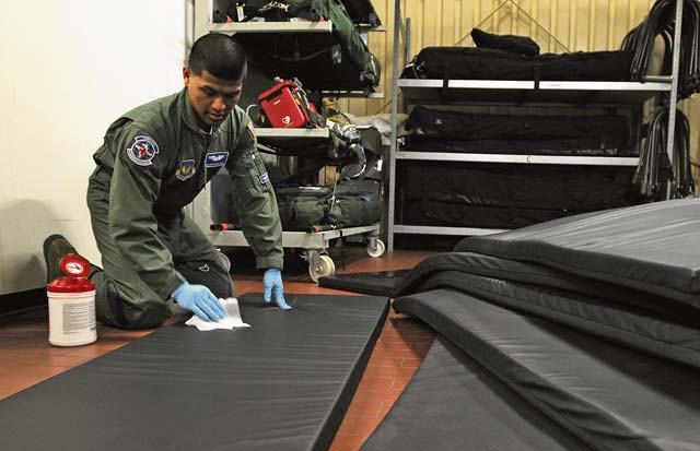 Senior Airman Don Caluya, 86th Aeromedical Evacuation Squadron aeromedical evacuation technician, cleans mats after an incoming flight Feb. 20 on Ramstein.