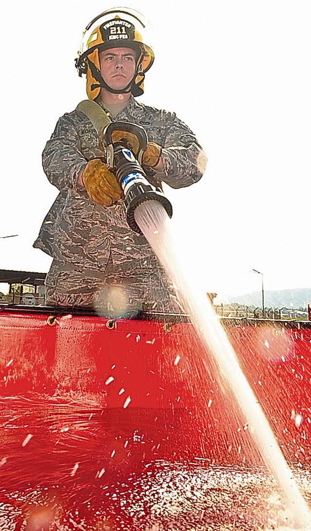 Photo by Airman 1st Class Michael StuartWater for firefightersAirman 1st Class Robert Schiffer, 86th Civil Engineer Squadron firefighter, fills up a pool of water that’s used to fill up a fire truck Aug. 28 on Ramstein. Hundreds of gallons of water are used to fill up the fire trucks.