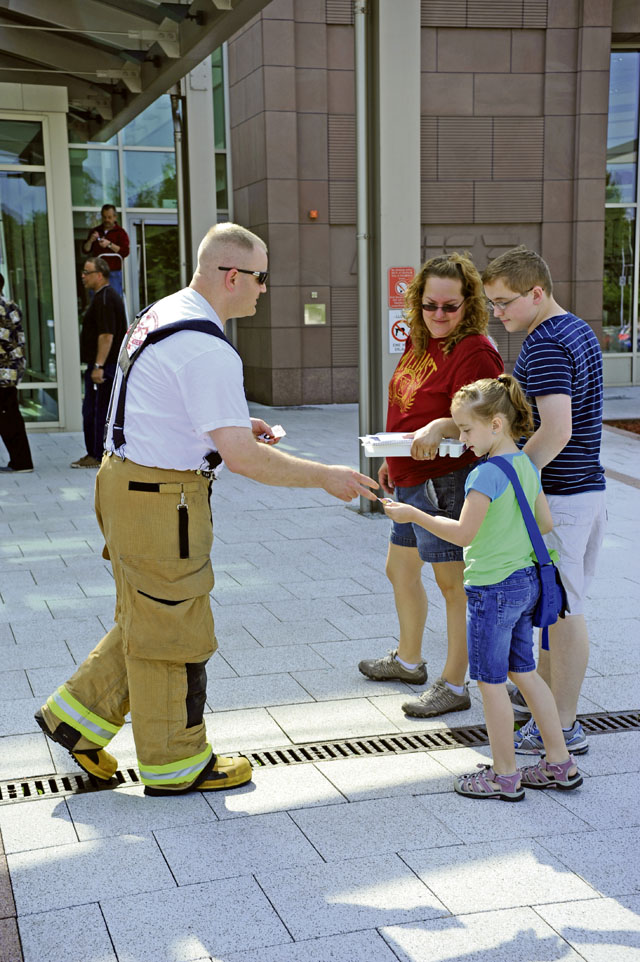 Photo by Airman 1st Class Hailey HauxFill the bootStaff Sgt. Anthony Drake, 86th Civil Engineer Squadron crew chief, passes out stickers to patrons in front of the base exchange during the annual “Fill the Boot” campaign July 2 on Ramstein. The campaign was started to raise money for different causes, such as muscular dystrophy.