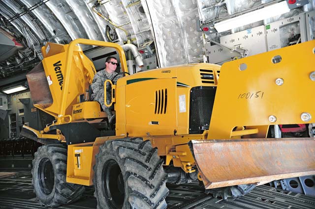 Photo by Senior Airman Hailey HauxAirmen visit 721st APSTech. Sgt. Matthew Foster, 87th Aerial Port Squadron air transportation specialist from Wright Patterson Air Force Base, Ohio, unloads a tractor from an aircraft Aug. 12 on Ramstein. A group of Airmen from Wright Patterson were TDY here for two weeks to gain more knowledge of the  processes Ramstein uses to unload aircraft. 