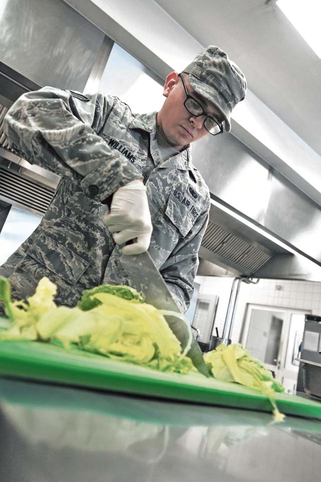 Photo by Senior Airman Aaron-Forrest WainwrightFresh foodSenior Airman Johnathan Williams, 86th Force Support Squadron food services specialist, chops lettuce for dinner at the Rheinland Inn Dining Facility on Ramstein. 