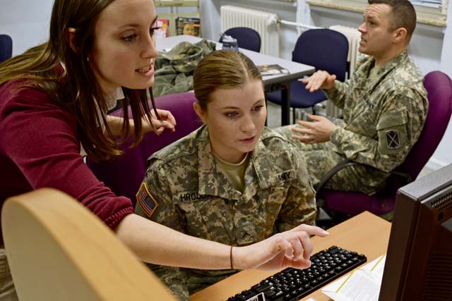 Marcy Carpenter, U.S. Army Garrison Rheinland-Pfalz education counselor aide, helps Pvt. Jamie Hrouda set up her account for Go ArmyEd, the Army’s portal into higher education assistance.