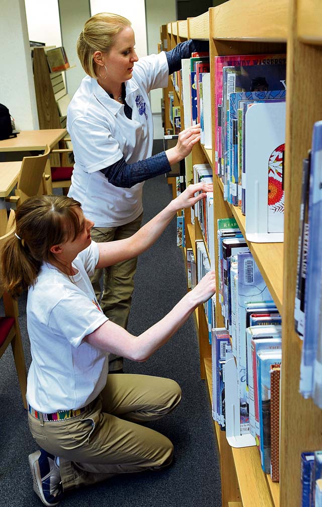 Photo by Airman 1st Class Trevor RhynesGood choiceAlison McKee (foreground), 86th Force Support Squadron librarian, and Jodi Brown, library volunteer,  organize shelves June 27 at the Ramstein Library. 