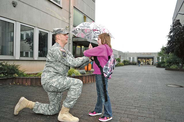 Photo by Spc. Iesha HowardFirst day of schoolStaff Sgt. Michael Allen, a military working dog liaison with the 95th Military Police Company, 18th MP Brigade, 21st Theater Sustainment Command, fixes his daughter Aveleyn’s jacket Aug. 26 at Sembach Middle School. Service members from around the KMC dropped their children off for their first day of school.