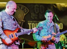 Photo by Senior Airman Trevor RhynesSpc. Brian Bunker (left), U.S. Army Europe band guitarist, and Staff Sgt. Alex Nikiforoff, U.S. Air Forces in Europe and Air Forces Africa band guitarist, participate in a battle of the bands during the 70th anniversary of American Forces Network Europe Sept. 14 on Ramstein. Over the past 70 years, AFN Europe has entertained service members over the radio, online and on television.