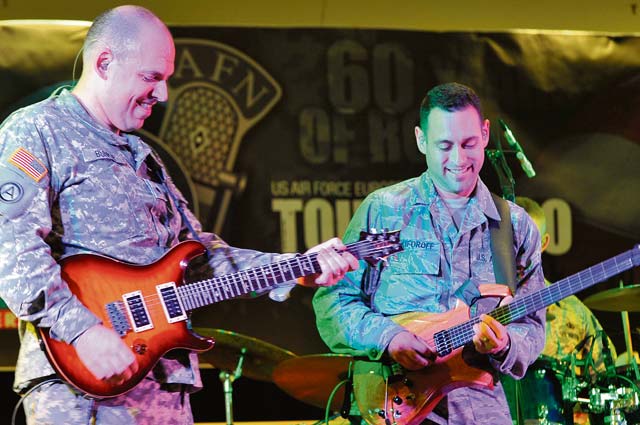 Photo by Senior Airman Trevor RhynesSpc. Brian Bunker (left), U.S. Army Europe band guitarist, and Staff Sgt. Alex Nikiforoff, U.S. Air Forces in Europe and Air Forces Africa band guitarist, participate in a battle of the bands during the 70th anniversary of American Forces Network Europe Sept. 14 on Ramstein. Over the past 70 years, AFN Europe has entertained service members over the radio, online and on television. 
