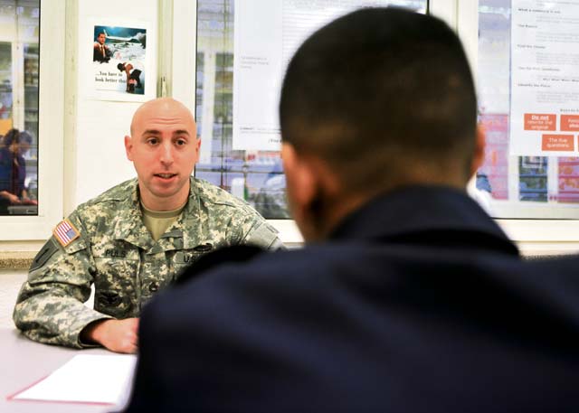 Sgt. 1st Class Justin D. Puls, the 21st Theater Sustainment Command’s senior retention operations NCO, discusses his military background with a Kaiserslautern High School student at the mentorship program orientation Nov. 6 on Vogelweh Military Complex.