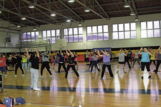 Soldiers from the 18th Military Police Brigade, fellow service members and civilians do Zumba, a form of cardiovascular dancing, during the U.S. Army Garrison Rheinland-Pfalz Sports and Fitness “Get Fit, Stay Fit” Fitness Expo Jan. 11 at the Sembach Fitness Center on Sembach Kaserne.
