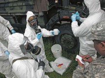 Staff Sgt. Wendell Reeder (right), survey team chief, 773rd Civil Support Team, 7th Civil Support Command, writes notes as he observes members of the HAZMAT Company, Civil Protection Regiment, Kosovo Security Forces, during a Defense Threat Reduction Agency-led exercise May 20.