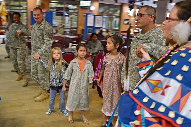 Photo by Rick ScavettaCol. Bryan DeCoster (left), commander of U.S. Army Garrison Rheinland-Pfalz, dances with community members, including  Capt. Phillip Castillo from New Mexico’s Pueblo tribe and Castillo’s daughters, Lia and Madeline. Sandra Namingha (right) and her husband, Lindbergh, taught the community traditional Native American dancing and songs during the National Native American Heritage Month event Nov. 15 at the Kazabra Club on Vogelweh.