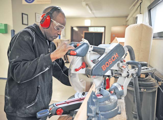 Army Sgt. Darrell Smith, 11th Missile Defense Detachment operation assistant, cuts a piece of lumber for a project May 2 at the Ramstein Arts and Crafts Center woodshop.
