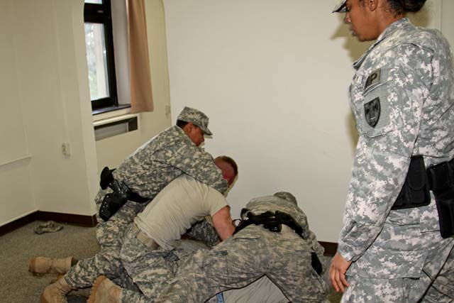 Soldiers of the 95th Military Police Battalion answer a call at the barracks and break up a simulated fight as part of the 95th Professional Law Enforcement Exercise Sept. 9 to 13 on Smith Barracks in Baumholder.