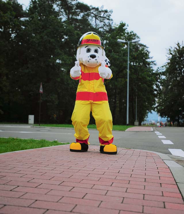Sparky the fire dog waves to passing drivers at the Ramstein Express gas station Oct. 8 during Fire Prevention Week. 