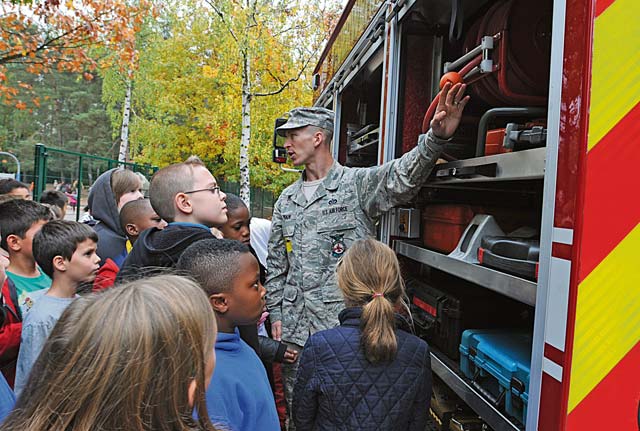 Staff Sgt. Gregory Ullman, 86th Civil Engineer Squadron fire prevention inspector, teaches students about the different parts of a fire truck Oct. 9 during Fire Prevention Week.